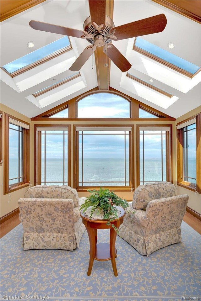 4150 Port Austin Rd, Caseville, MI 48725 - living area featuring a skylight, vaulted ceiling, plenty of natural light, a water view, and ceiling fan