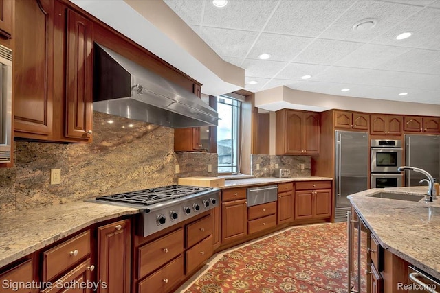 4150 Port Austin Rd, Caseville, MI 48725 - kitchen featuring stainless steel appliances, wall chimney range hood, a warming drawer, light stone countertops, and a sink