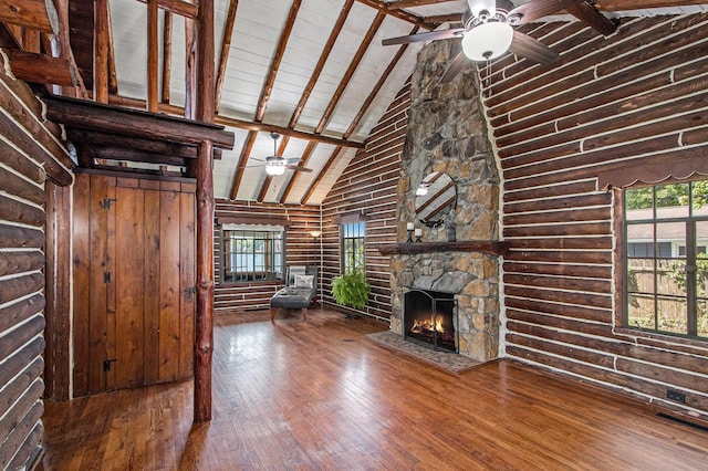 146 Crooked Lake Dr W, Kalamazoo, MI 49009 - unfurnished living room featuring a ceiling fan, hardwood / wood-style flooring, log walls, healthy amount of natural light, and high vaulted ceiling