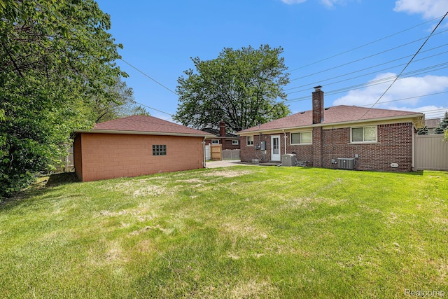 5239 E 13 Mile Rd, Warren, MI 48092 - back of property featuring cooling unit, a chimney, brick siding, and a patio