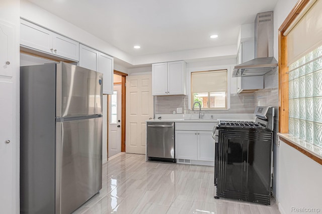 5239 E 13 Mile Rd, Warren, MI 48092 - kitchen with stainless steel appliances, wall chimney range hood, a sink, white cabinetry, and recessed lighting