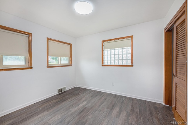5239 E 13 Mile Rd, Warren, MI 48092 - unfurnished bedroom with dark wood finished floors, a closet, and baseboards