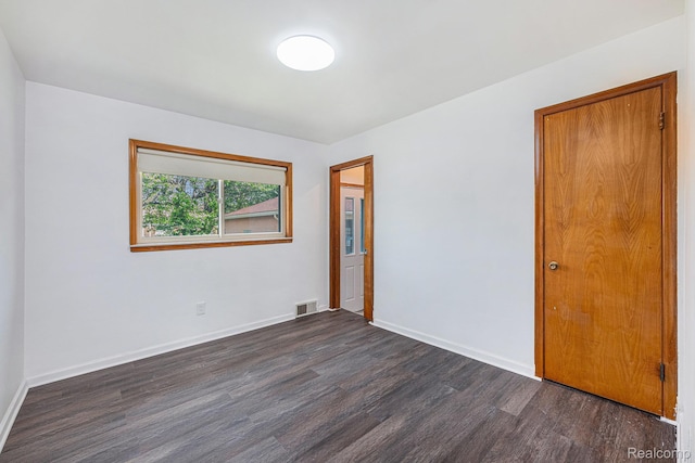 5239 E 13 Mile Rd, Warren, MI 48092 - empty room with dark wood-style floors and baseboards