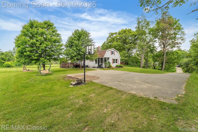 917 Middle Rd, Highland, MI 48357 - view of green lawn featuring view of wooded area and a wooden deck
