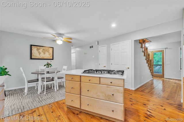 917 Middle Rd, Highland, MI 48357 - kitchen featuring stainless steel gas cooktop, light wood-style floors, ceiling fan, light countertops, and baseboards