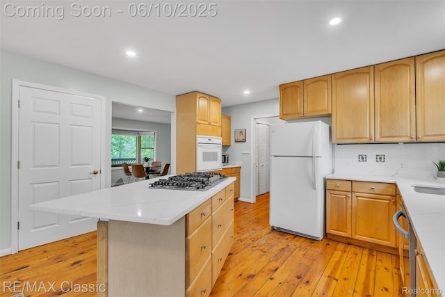 917 Middle Rd, Highland, MI 48357 - kitchen with appliances with stainless steel finishes, light wood-style flooring, recessed lighting, a sink, and a kitchen island