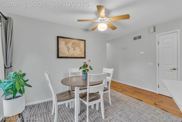 917 Middle Rd, Highland, MI 48357 - dining space featuring wood finished floors, a ceiling fan, and baseboards