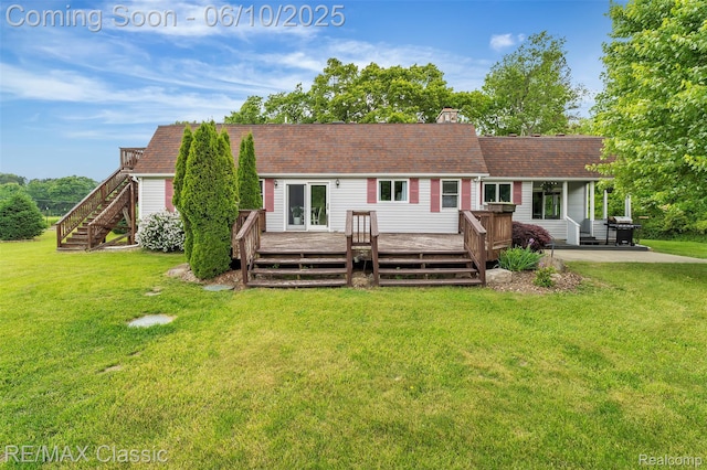 917 Middle Rd, Highland, MI 48357 - rear view of property with a deck, a chimney, a lawn, and roof with shingles