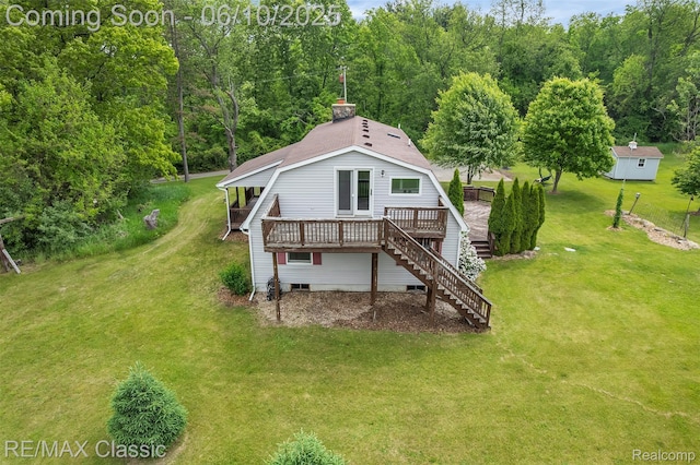 917 Middle Rd, Highland, MI 48357 - rear view of house featuring stairway, a wooden deck, a lawn, and a forest view
