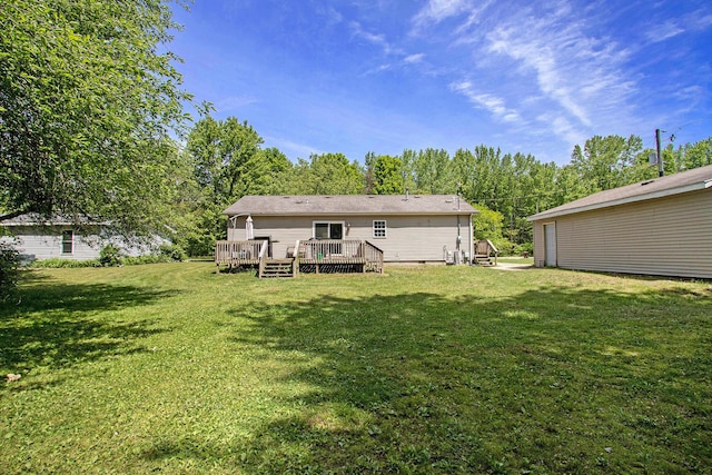 1417 Greenhouse Rd, Bangor, MI 49013 - back of house with a yard, crawl space, a wooden deck, and view of wooded area