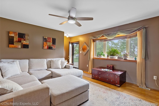 38505 Littlefield Dr, Sterling Heights, MI 48312 - living room with wood finished floors, ceiling fan, and baseboards