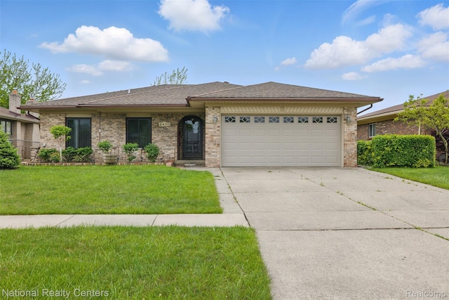 2430 Fox Hill Dr, Sterling Heights, MI 48310 - ranch-style house featuring driveway, an attached garage, a front yard, and brick siding