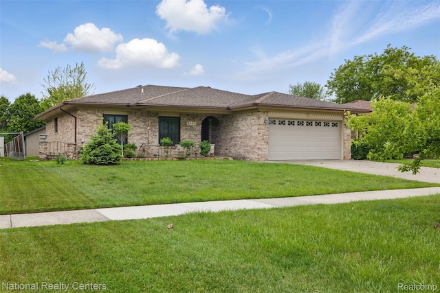 2430 Fox Hill Dr, Sterling Heights, MI 48310 - single story home featuring driveway, an attached garage, a front yard, and brick siding