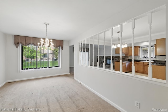 2430 Fox Hill Dr, Sterling Heights, MI 48310 - unfurnished dining area featuring a chandelier, a sink, baseboards, and light carpet