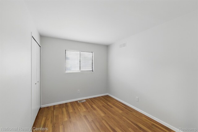 2430 Fox Hill Dr, Sterling Heights, MI 48310 - unfurnished room featuring baseboards and wood finished floors