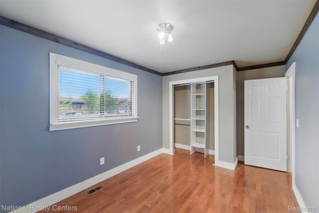 2430 Fox Hill Dr, Sterling Heights, MI 48310 - unfurnished bedroom with baseboards, light wood-type flooring, a closet, and crown molding