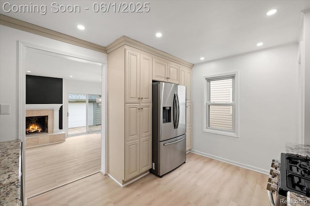 22923 Madison St, Dearborn, MI 48124 - kitchen featuring stainless steel refrigerator with ice dispenser, cream cabinetry, light wood-style floors, plenty of natural light, and recessed lighting
