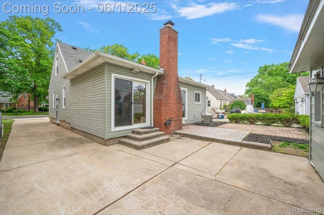 22923 Madison St, Dearborn, MI 48124 - back of house featuring a patio area, a chimney, and entry steps