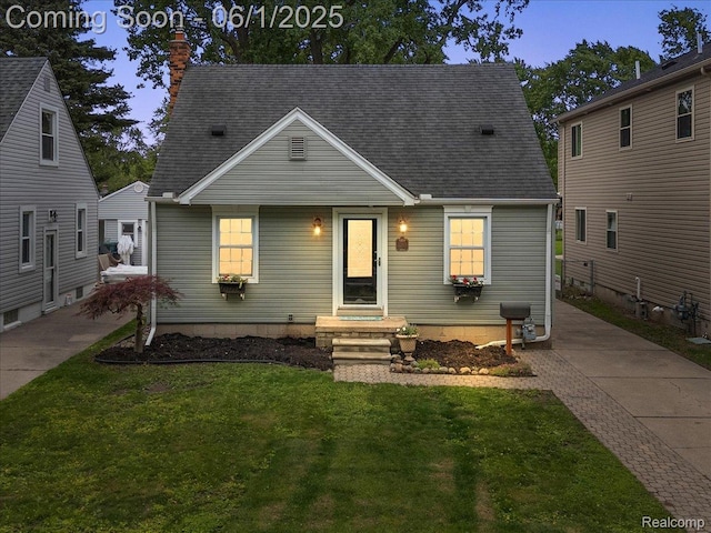 22923 Madison St, Dearborn, MI 48124 - view of front of house with a front lawn, a chimney, and a shingled roof