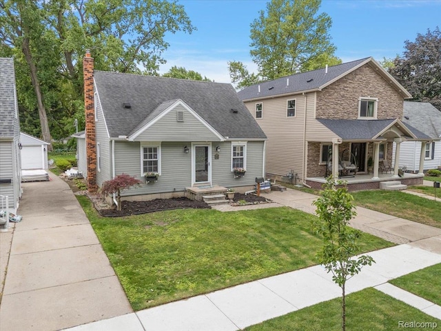 22923 Madison St, Dearborn, MI 48124 - view of front of home with a front lawn, an outdoor structure, a chimney, and stone siding