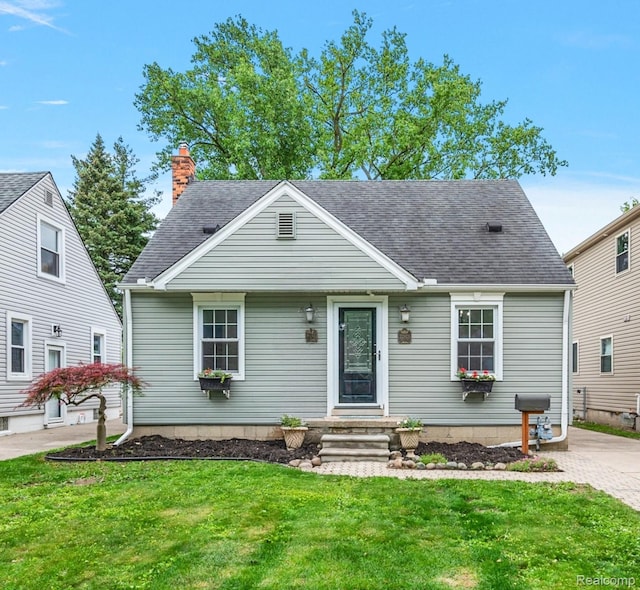 22923 Madison St, Dearborn, MI 48124 - view of front of house with a front yard, roof with shingles, and a chimney