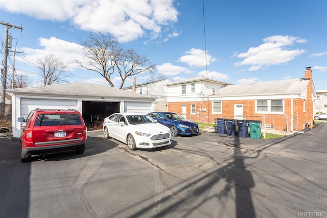 4811 Briarwood Ave, Royal Oak, MI 48073 - view of front of home featuring brick siding, a detached garage, and an outbuilding
