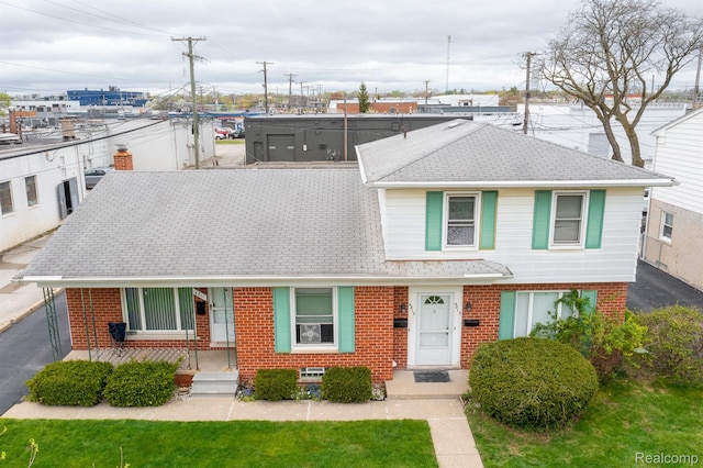 4811 Briarwood Ave, Royal Oak, MI 48073 - view of front of home featuring brick siding, roof with shingles, and a front lawn