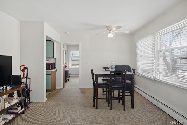 4811 Briarwood Ave, Royal Oak, MI 48073 - dining area featuring baseboard heating, a ceiling fan, light carpet, a baseboard radiator, and baseboards