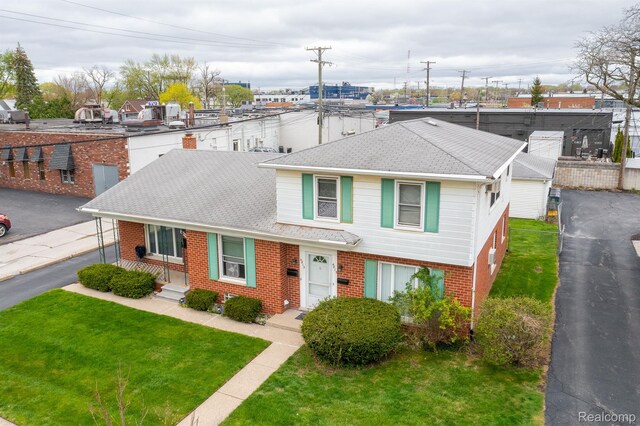 4811 Briarwood Ave, Royal Oak, MI 48073 - view of front of home featuring brick siding, a shingled roof, and a front lawn