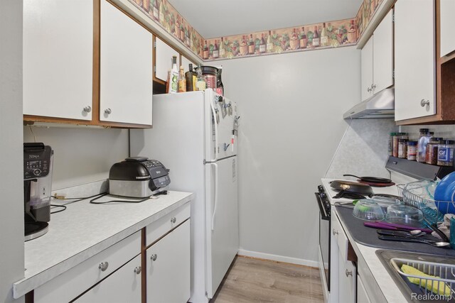 4811 Briarwood Ave, Royal Oak, MI 48073 - kitchen featuring under cabinet range hood, white appliances, light countertops, white cabinetry, and light wood-type flooring