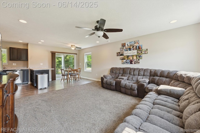 5200 Autumn Kirsten Dr, Fowlerville, MI 48836 - living room with recessed lighting, dark wood-style floors, a ceiling fan, and dark carpet