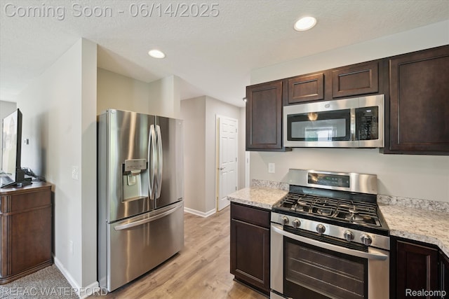 5200 Autumn Kirsten Dr, Fowlerville, MI 48836 - kitchen featuring stainless steel appliances, dark brown cabinets, light countertops, recessed lighting, and a textured ceiling