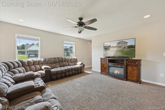 5200 Autumn Kirsten Dr, Fowlerville, MI 48836 - carpeted living room featuring ceiling fan, recessed lighting, and a glass covered fireplace