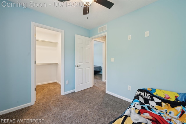 5200 Autumn Kirsten Dr, Fowlerville, MI 48836 - carpeted bedroom with a walk in closet and ceiling fan