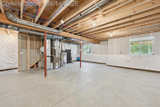 5200 Autumn Kirsten Dr, Fowlerville, MI 48836 - basement with plenty of natural light, water heater, and heating unit