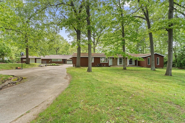 2240 S 13th St, Niles, MI 49120 - single story home with driveway, a front lawn, and view of scattered trees