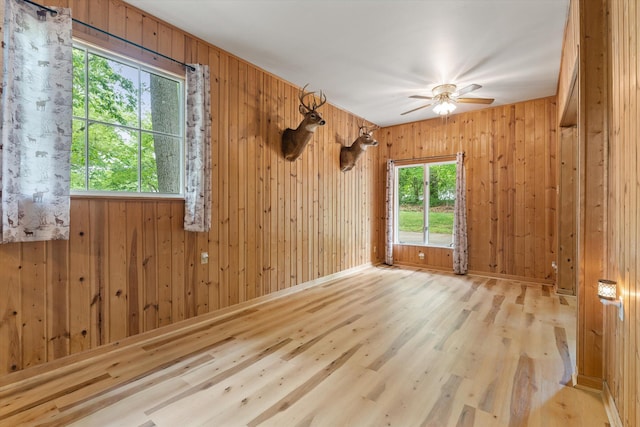 2240 S 13th St, Niles, MI 49120 - spare room with a ceiling fan, wood finished floors, and wooden walls