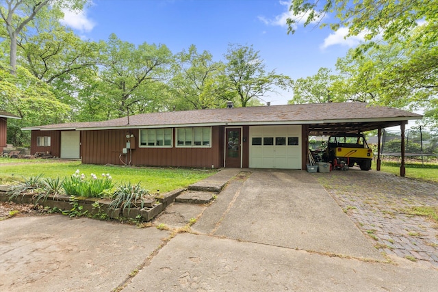 2240 S 13th St, Niles, MI 49120 - view of front of home featuring an attached garage, a carport, a front lawn, asphalt driveway, and board and batten siding