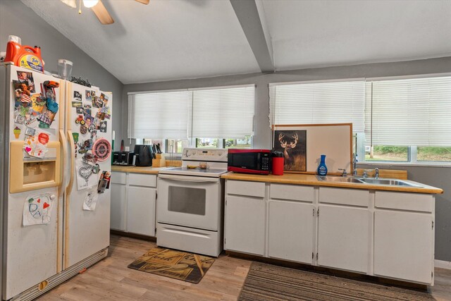 2240 S 13th St, Niles, MI 49120 - kitchen featuring white appliances, light wood-style floors, white cabinetry, healthy amount of natural light, and lofted ceiling