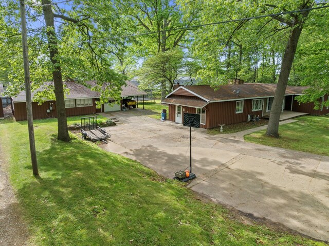 2240 S 13th St, Niles, MI 49120 - view of front of home with driveway, a front lawn, a carport, and roof with shingles