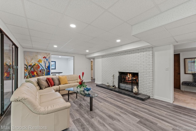 4355 Middleton Dr, Bloomfield Hills, MI 48302 - living area featuring wood finished floors, a brick fireplace, a drop ceiling, baseboards, and recessed lighting