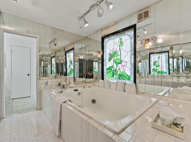 4355 Middleton Dr, Bloomfield Hills, MI 48302 - bathroom featuring a jetted tub, tile patterned floors, a textured ceiling, and track lighting