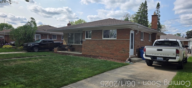 26312 Warrington St, Dearborn Heights, MI 48127 - view of front of house featuring a chimney, brick siding, and a front lawn