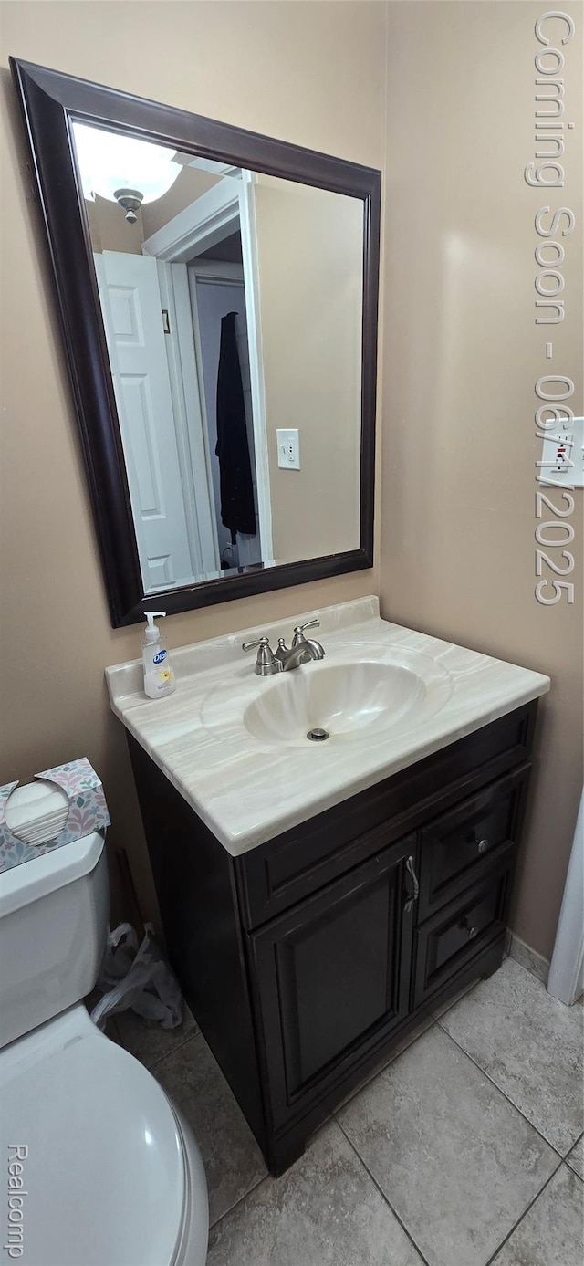 26312 Warrington St, Dearborn Heights, MI 48127 - bathroom with toilet, vanity, and tile patterned flooring