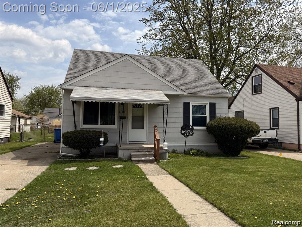 24650 Columbus Ave, Warren, MI 48089 - bungalow-style house featuring a shingled roof, a front lawn, and concrete driveway