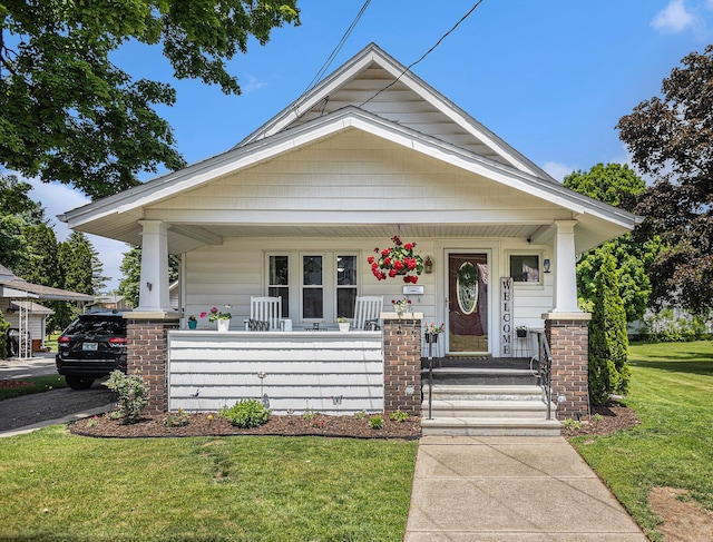 241 E Corey St, Bronson, MI 49028 - shotgun-style home with covered porch and a front lawn