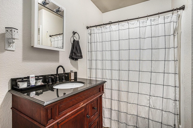241 E Corey St, Bronson, MI 49028 - bathroom with vanity, curtained shower, and a textured wall