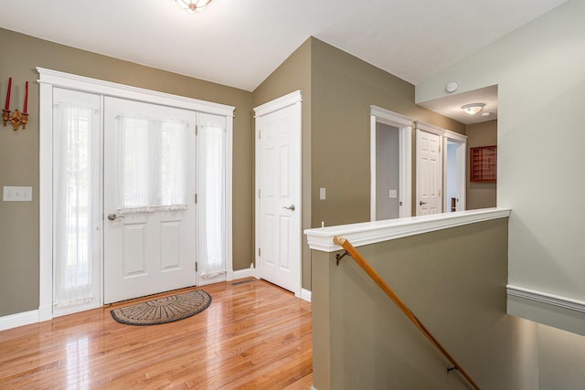 1407 S Dibble St, Hastings, MI 49058 - foyer with light wood-type flooring, baseboards, and vaulted ceiling