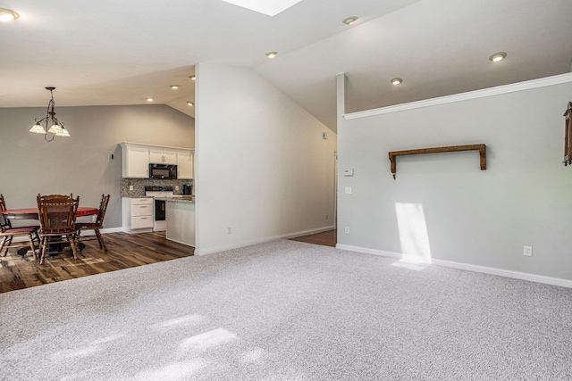 1407 S Dibble St, Hastings, MI 49058 - living room with lofted ceiling, a chandelier, dark colored carpet, baseboards, and recessed lighting
