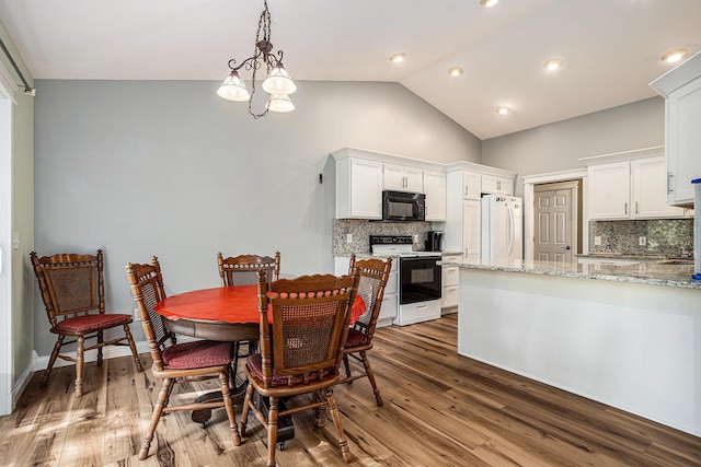 1407 S Dibble St, Hastings, MI 49058 - dining area featuring wood finished floors and high vaulted ceiling